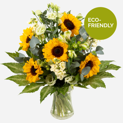 Sunny Spells - Sunshine, showers and beautiful flowers … The magnificent sunflower with an attendance of beautiful blossoms to complement, upheld with bright foliage.
